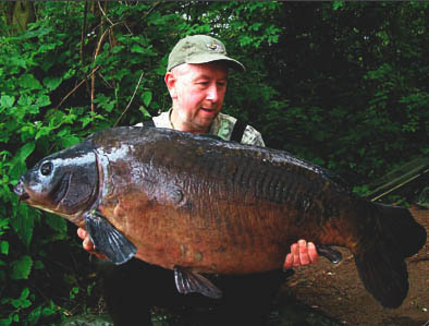 The Black Mirror, with Steve Briggs, who caught the famous old carp earlier this summer.
