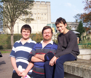 David Overland (centre), seen here with his sons, is the new AM Poet Laureate! Find out why in the mag, and at our online video - set to music by guitar maestro Paul Brett.