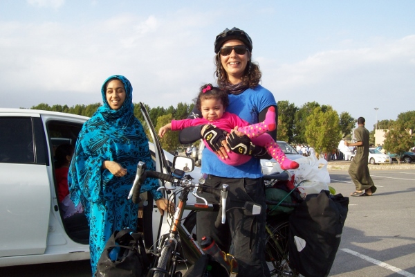 Cycle tourist Rubina Soorty with two members of her Omani host family at the Tour of Oman