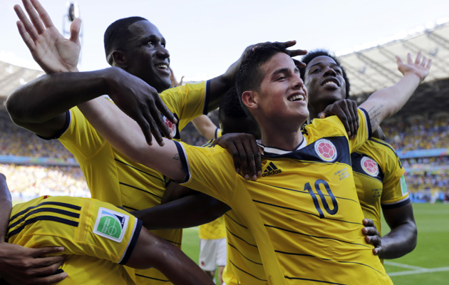 Colombia players celebrate their third goal against Greece.