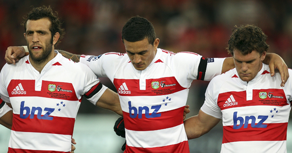 (L-R) Adam Whitelock, Sonny Bill Williams and Matt Todd of the Crusaders observe a minute of silence for victims of the earthquake
