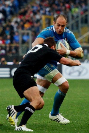 Bruiser: Sergio Parisse fends off the All Blacks