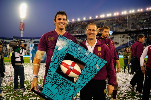 The World's worst trophy?: Lancaster and Wood celebrate an England victory
