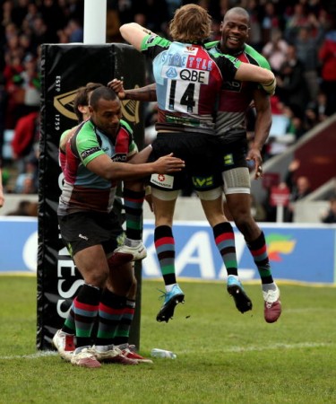 Jumping for joy: Strettle in his Harlequins days, celebrating with Ugo Monye
