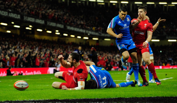 Sticky start: Esposito (14) is flat out on the turf as Alex Cuthbert (left) celebrates his try