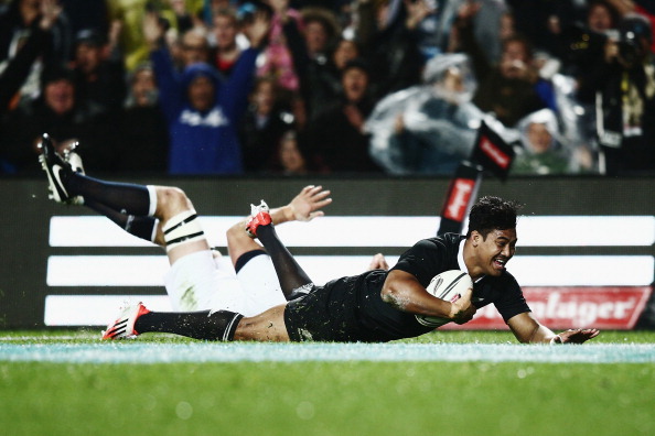 Try and stop me: Julian Savea scores the second try of his hat-trick in New Zealand's 17th win